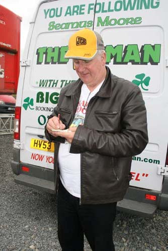 At the 2009 Summer Concert at Startrax, Knocknagree,  Séamus Moore (whose “JCB Man” song was such a great success) signs an autograph