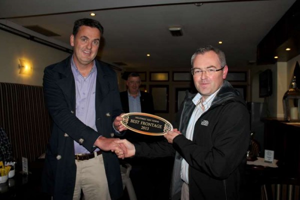 Thomas Mulcahy of Mulchay's Pharmacy, The Square, Millstreet receives his prestigious Award for best Frontage Business Premises from Chairman of Millstreet Tidy Towns, Derry Sheehan.