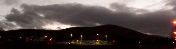 Despite the inclement weather we've been experiencing the superb new Astro Turf Pitch is in constant use as witnessed here this February evening with Clara Mountain in the background.   Click on the image to enlarge. (S.R.)