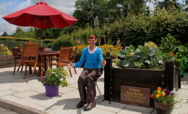 Julia Murphy who officially opened the magnificent new Clara Garden at Millstreet Day Care Centre in Clara Road on 16th April is clearly hugely impressed by the superb new plaque recently put in place at the Garden.  Donie, son of Julia, accompanied his mother to view this truly uplifting garden scene.   Great credit is due to all who brought this exquisite Garden and its Plaque to reality.   Click on the images to enlarge.  (S.R.)