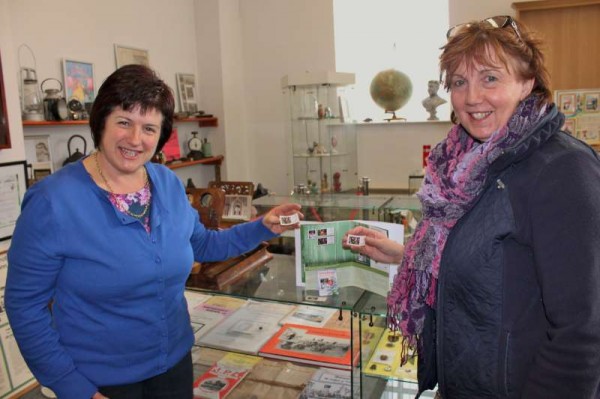 Patricia Moynihan of An Post shares the truly historic occasion of the now famous Millstreet Christmas Stamp arriving in Millstreet on Tuesday, 11th Nov. 2014 - Patricia (on right) is pictured at Millstreet Museum .  Below we observe the stamp which was presented by Patricia to Millstreet Museum and we also share an image of the Church Window where we note the detail on the second division showing the angel with the blue halo on the left.   Click on the images to enlarge.  (S.R.)