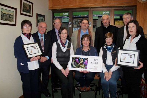 Official Launch of the Millstreet Christmas Stamp at Millstreet Post Office on Monday, 1st December.  Included are the Staff of Millstreet Post Office, from left: Anne, Margaret, Patricia and Noreen.  Standing from left Seán (Museum), Frank (An Post, Cork),  Bill (photographer of stained glass window which appears on the stamp), Canon John,Donal (who recently retired from Cork G.P.O.) and Julie (Sacristan).  More pictures to follow later.  Click on the image to enlarge.  (S.R.)