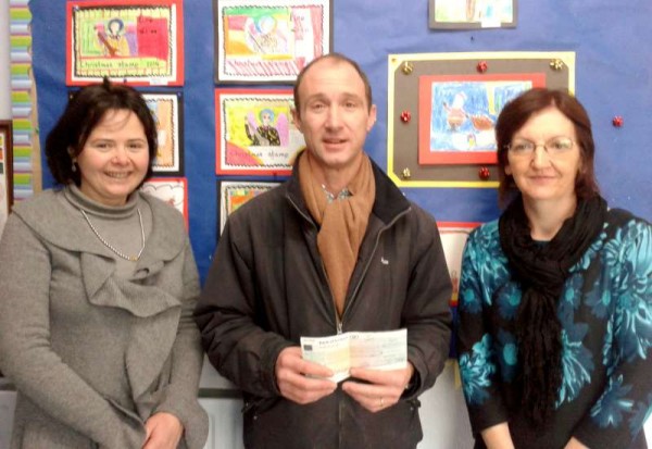 Parents' Association present a cheque to Scoil Mhuire, Millstreet BNS.  From left: Rose Murphy, Frank O ' Connor (Principal) and Sheila Lane.  Note in the background the wonderfully artistic work of the children depicting the Millstreet Christmas Stamp. Click on the images to enlarge.  (S.R.)