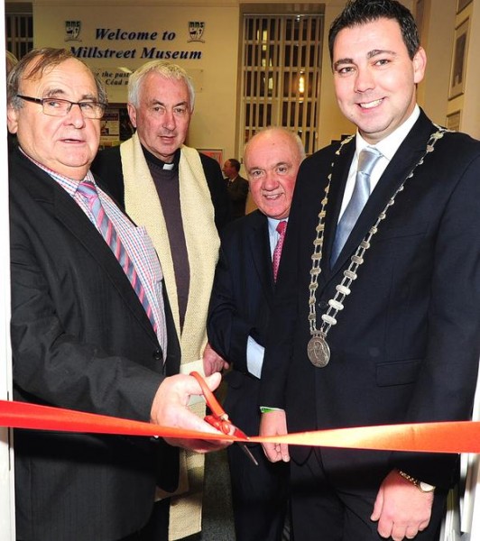 Noel Buckley cuts the tape officialy reopening Millstreet Museum, with Fr. John Fitzgerald, Seán Radley, and Cork County Mayor John Paul O'Shea - photo by John Tarrant